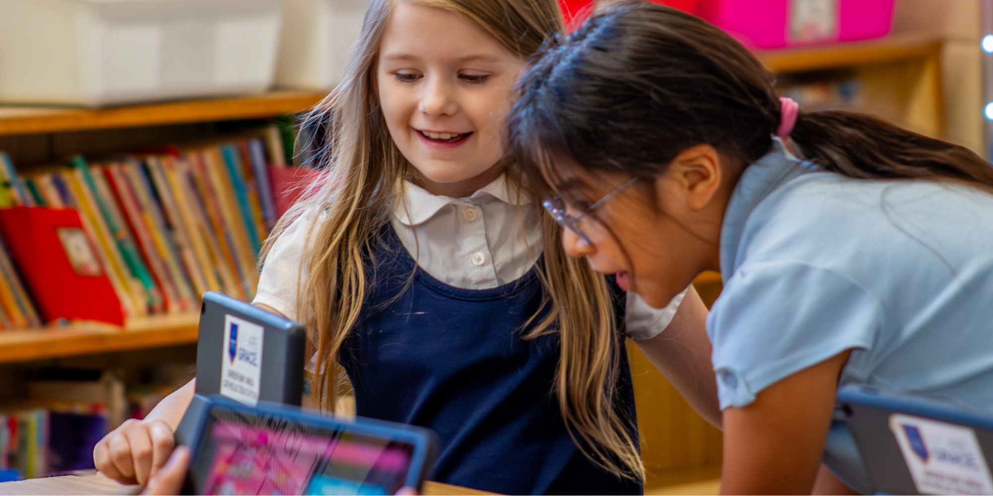 Two female Holy Family Catholic School students in the classroom